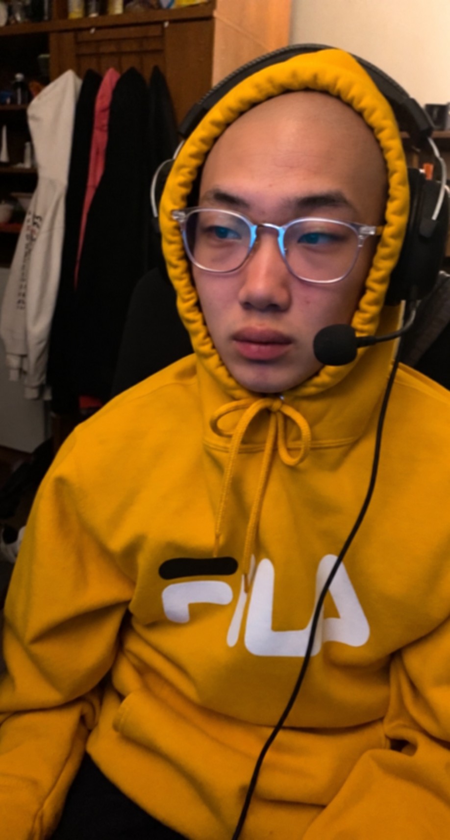 In Ha Chun wearing a yellow hoodie and headset